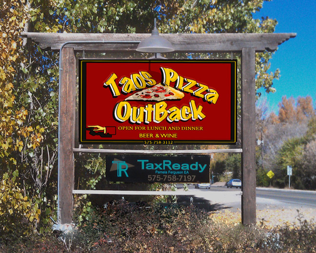 Taos Pizza Out Back roadside sign on Paseo Del Pueblo Norte